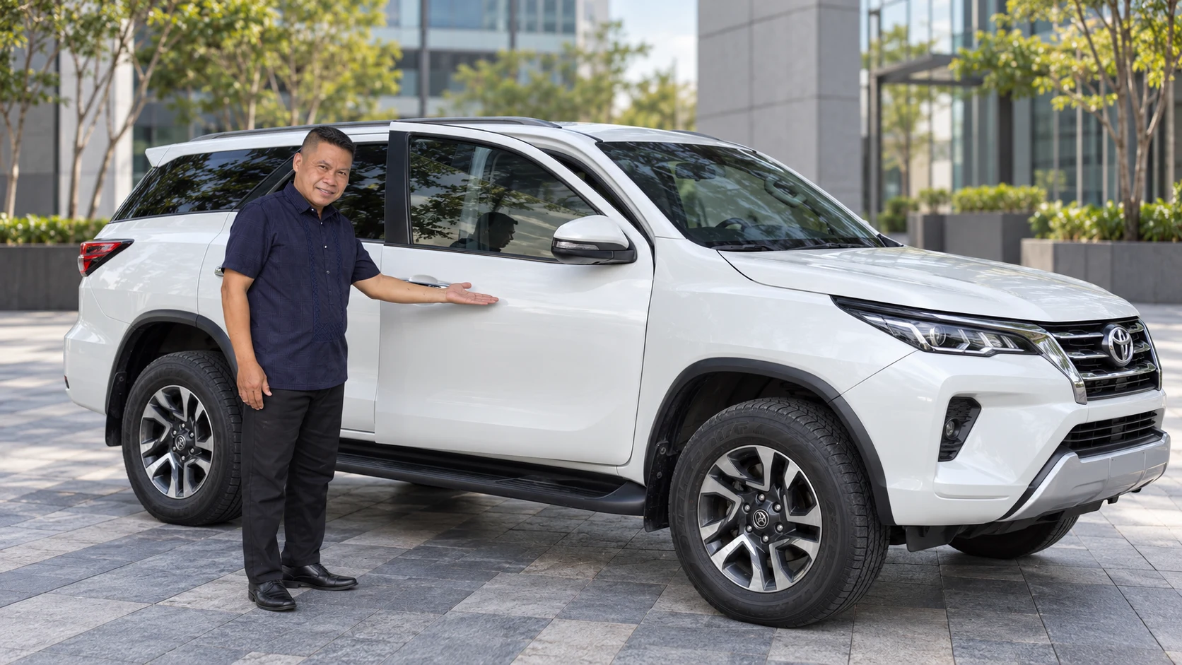 Continental chauffeur beside a white Toyota Fortuner
